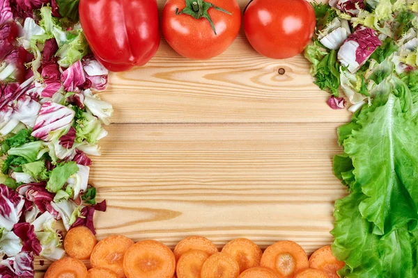 Rahmen aus frischem Gemüse auf Holzuntergrund. gesunde natürliche Lebensmittel auf dem Tisch mit Kopierraum. Kochzutaten von oben, Attrappe für Rezept oder Menü. — Stockfoto