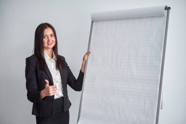 Flipchart Office yakın duran genç gülümseyen iş kadını portresi