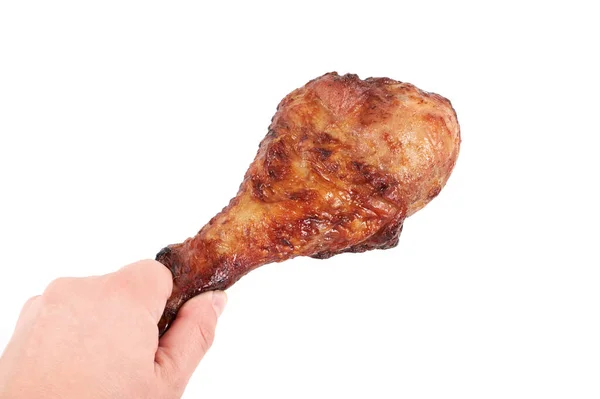 Close up and isolated image of hand holding a grilled turkey leg on white background. — Stock Photo, Image