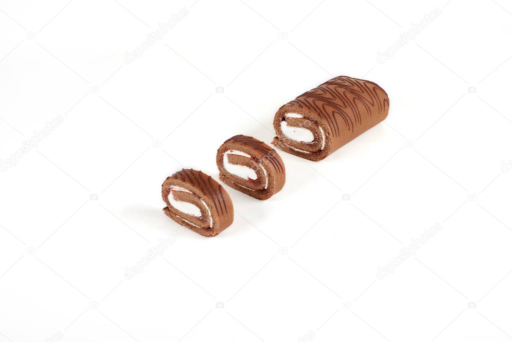 Sliced chocolate biscuit roll cake isolated on white background.