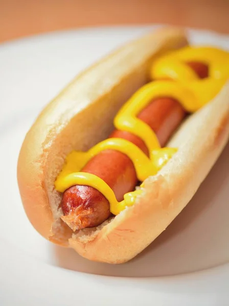 Hot dog with mustard in a bun — Stock Photo, Image