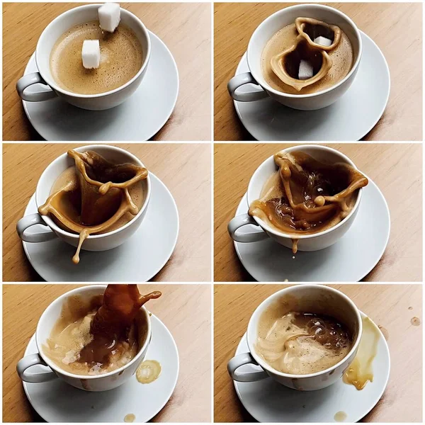 机の上のコップからコーヒーとスプラッシュコーヒーに落ちる2つの砂糖キューブ 要旨集 — ストック写真