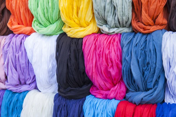 Multi-colored scarfs on a show-window of shop — Stock Photo, Image