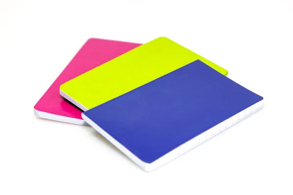 Uneven pile of multi-colored notebooks on a table — Stock Photo, Image