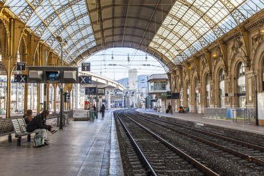 NICE, FRANCE, on JANUARY 6, 2017. The sun lights the platform of the railway station clipart