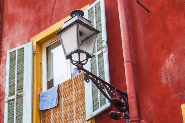 NICE, FRANCE, on JANUARY 8, 2017. A beautiful ancient lamp against the background of architecture of the old city