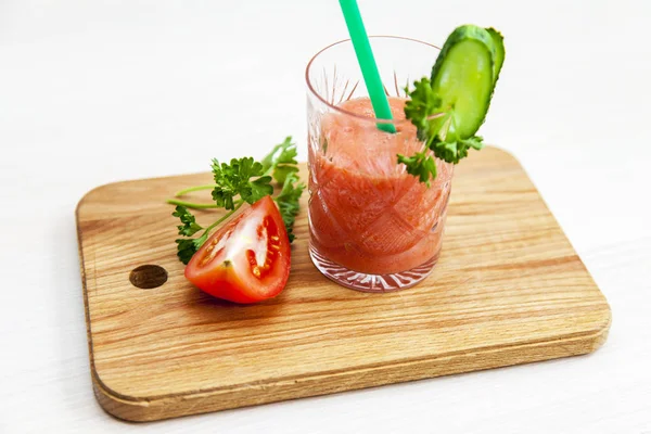 Vegetable smoothie in a crystal glass on a table