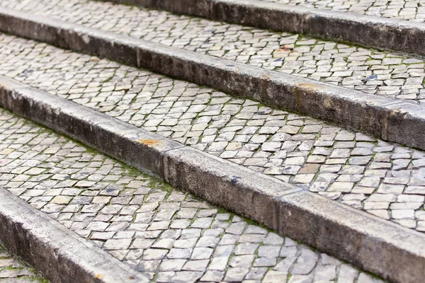 Texture of the old ladder paved with a stone