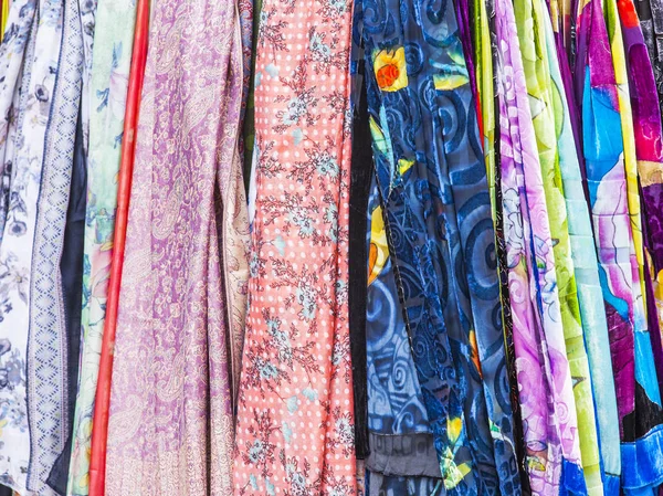 Multi-colored fabrics on a counter of shop — Stock Photo, Image