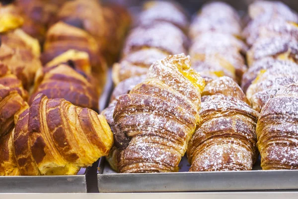 Tasty fresh croissants on a counter in shop — Stock Photo, Image