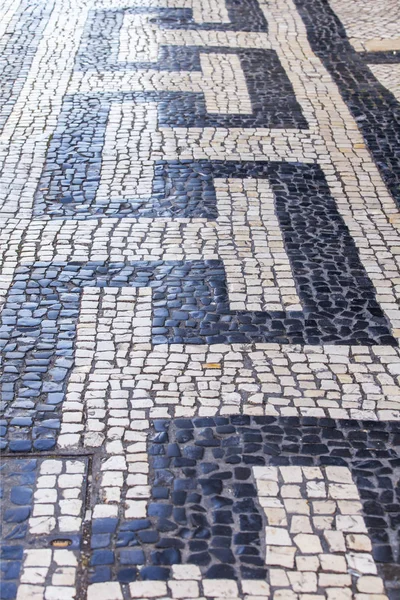 LISBON, PORTUGAL, on June 22, 2017. The traditional pattern which is laid out by stone blocks decorates the sidewalk of in downtown — Stock Photo, Image
