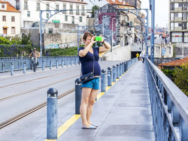 Porto, Portugalia, na 17 czerwca 2017 r. Młoda kobieta fotografie miasta na Ponte Luis I most przez rzekę Douro — Zdjęcie stockowe