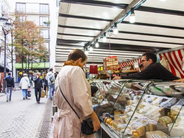 Paris, Fransa, üzerinde 27 Ekim 2017. İnsanlar şehrin altında açık havada sokak geleneksel çiftçi piyasasında dükkanda. Çeşitli peynirler bir gösteri-pencere sunulmaktadır