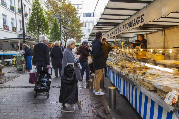 Paříž, Francie, na 27 října 2017. Lidé nakupují v tradiční zemědělce trhu na náměstí pod širým nebem. Různé sýry jsou uvedeny v okně Zobrazit — Stock fotografie