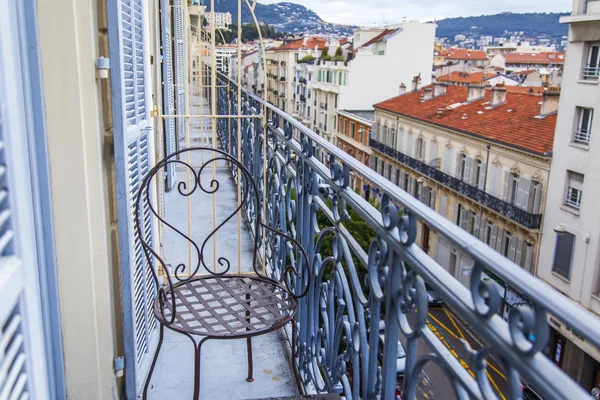 Stock image NICE, FRANCE, on March 6, 2018. A view from a balcony in Provencal style on picturesque city buildings in the downtown. The beautiful decorative grid guards a balcony