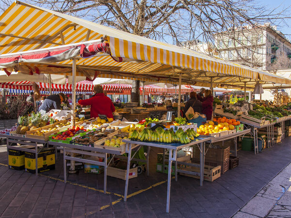 NICE, FRANCE, on March 7, 2018. Various vegetables and fruit are laid out on counters of the well-known Cours Saleya market. 