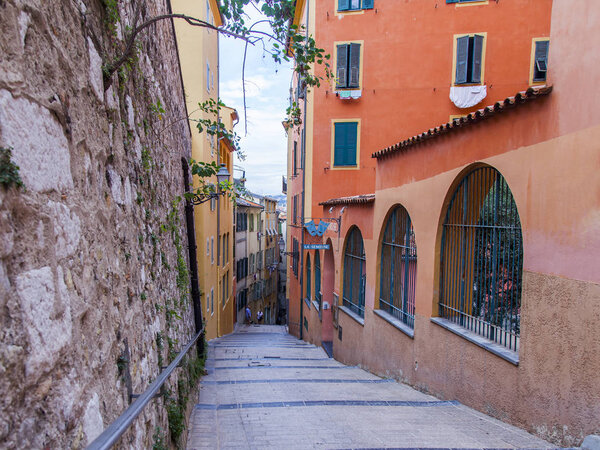 Nice, France, October 8, 2019. Picturesque narrow street in the old town on the slope of the hill