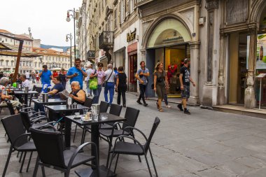 Trieste, İtalya, 5 Ağustos 2019. Tarihi şehirde pitoresk bir caddenin kaldırımında çekici kafe masaları.