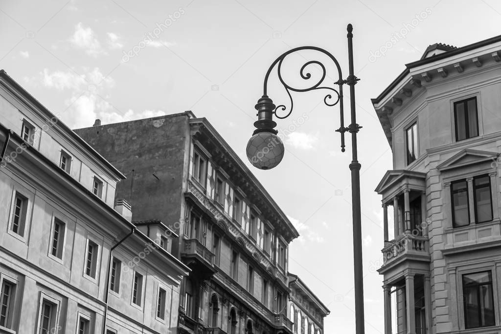 Trieste, Italy, August 5, 2019. Fragment of the facade of a typical building in the old city. Beautiful street lamp