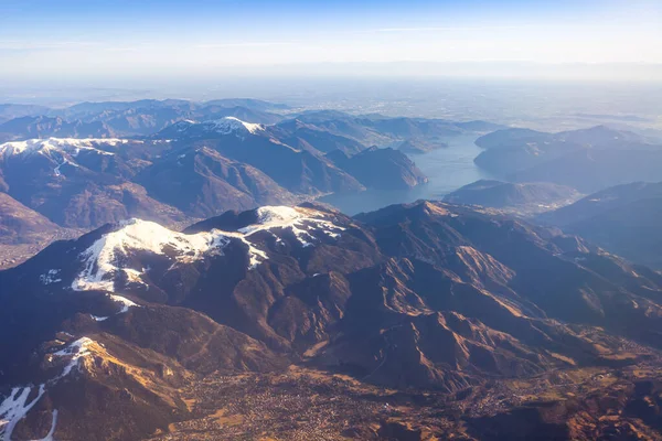 The view from the airplane window on a picturesque mountains landscape