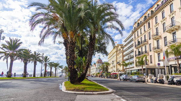 Nice, France, October 10, 2019. Urban view. Beautiful palm trees on Promenade des Anglais waterfront 