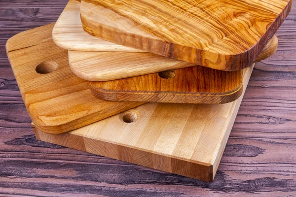 Uneven stack of wooden kitchen chopping boards
