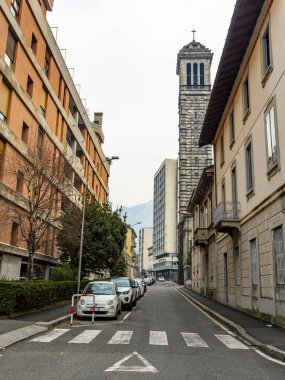 Lecco, İtalya, 16 Şubat 2020. Tarihi bir binada tipik şehir manzarası. İnsanlar güzel bir caddede yürüyorlar.