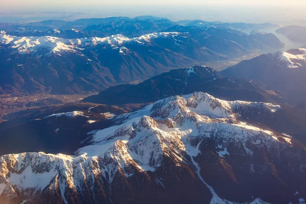 The view from the airplane window on a picturesque mountains landscape