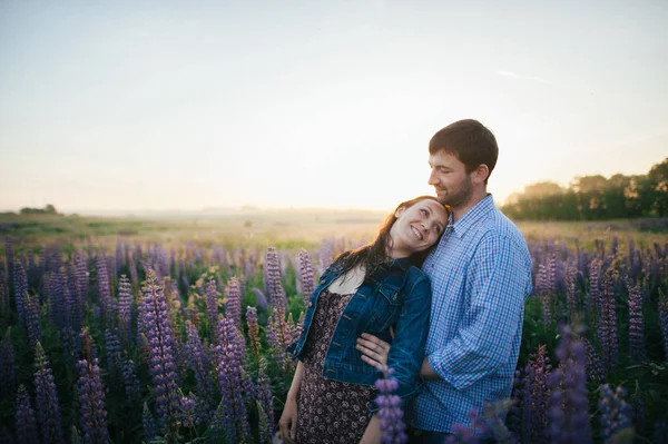 couple in field of flowers in sunset