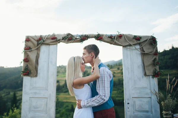 young couple near wedding frame