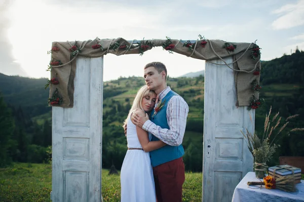 Молодая пара возле свадебной рамки — стоковое фото