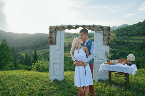 couple near wedding frame