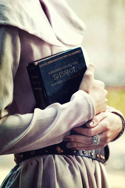 Female hands holding Holy book — Stock Photo, Image