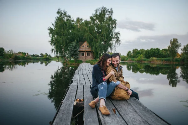 Romantic couple on wooden bridge — Stock Photo, Image