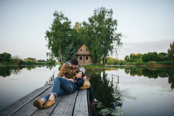 Romantic couple on wooden bridge — Stock Photo, Image