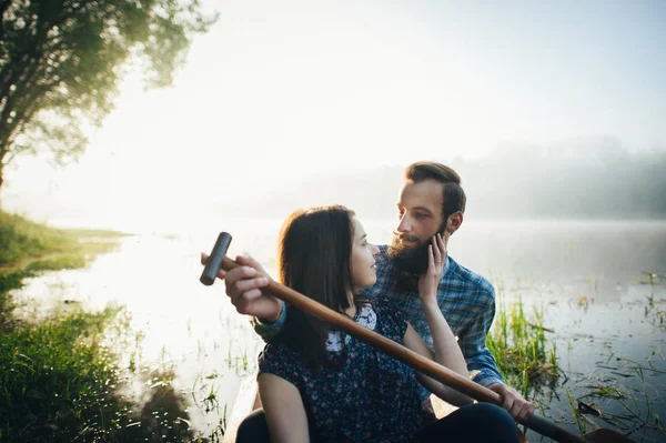 Vrouw met man zitten in kano — Stockfoto