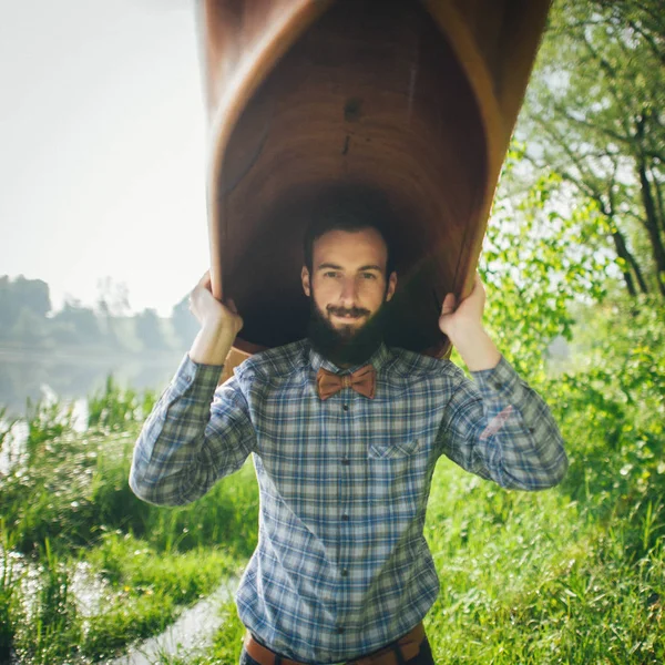 Handsome man holding canoe — Stock Photo, Image