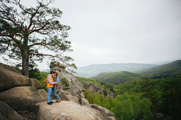 Pár stojící na rocky mountain — Stock fotografie