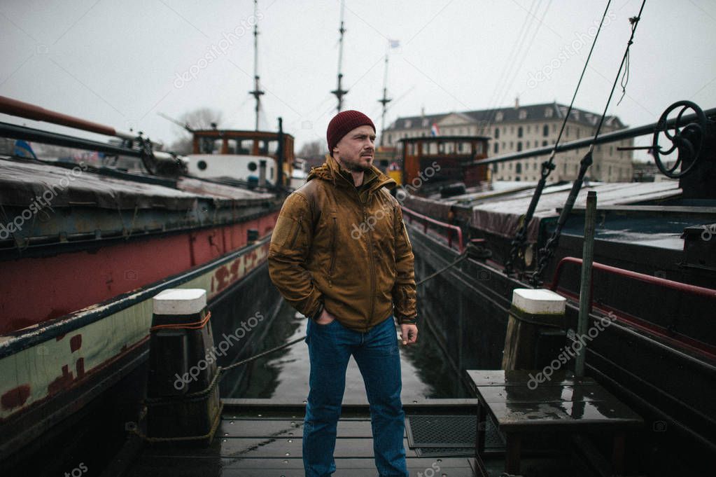 Man standing at pier in Amsterdam marina