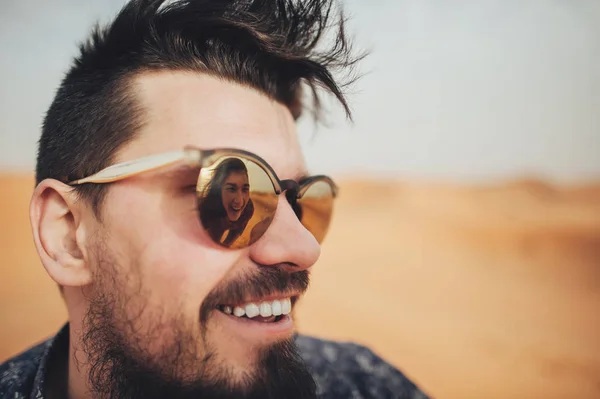 Man in sunglasses with reflection of young woman — Stock Photo, Image