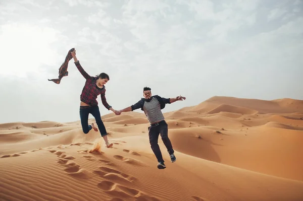 Couple of travelers in desert Sahara Stock Photo