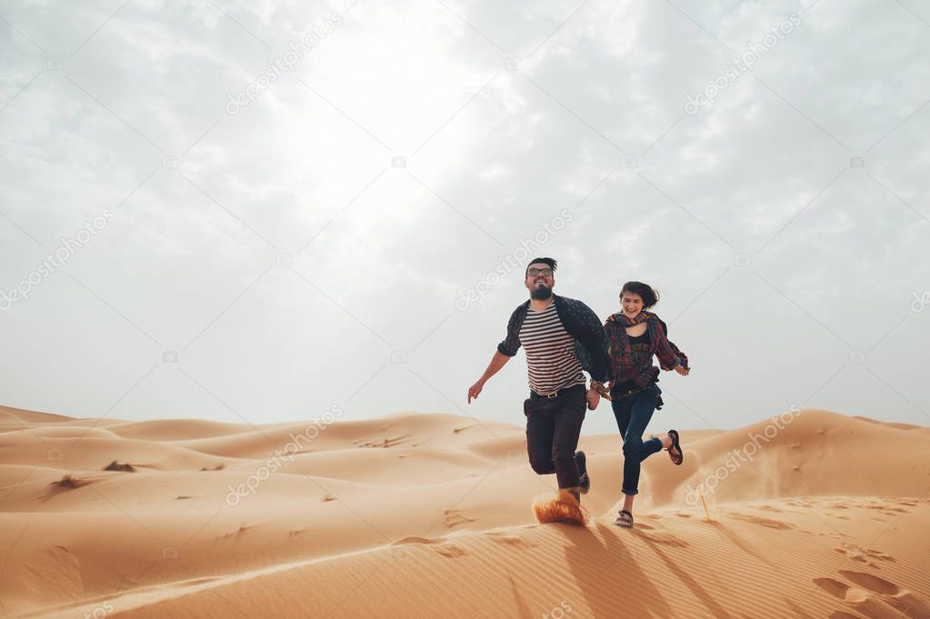 Couple of travelers in desert Sahara