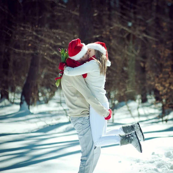 Couple hugging and kissing on snowy glade — Stock Photo, Image