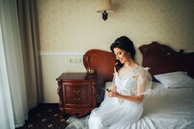 Otel Oda oturan yaka çiçeği ile mutlu gelin gülümseyen