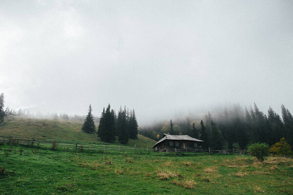 Lonely old house in woody mountains 