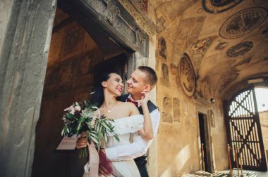 Gülümseyen iki eski İtalyanca duvara yakın sarılma