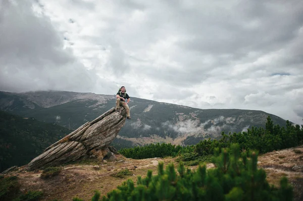 Pria Yang Duduk Atas Batu Dengan Pemandangan Indah Latar Belakang — Stok Foto