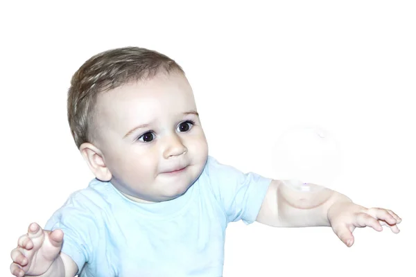 Cute baby looks at the soap bubble admiringly isolate — Stock Photo, Image