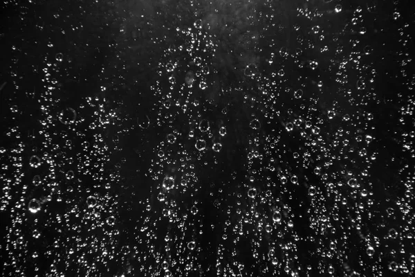 Rain drops on the glass on a black background — Stock Photo, Image