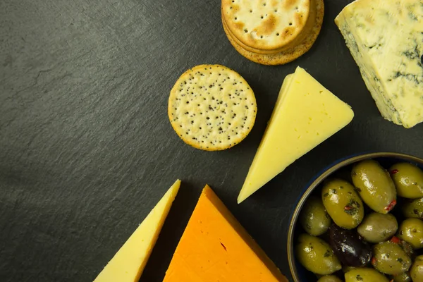 Cheese platter with olives and biscuits